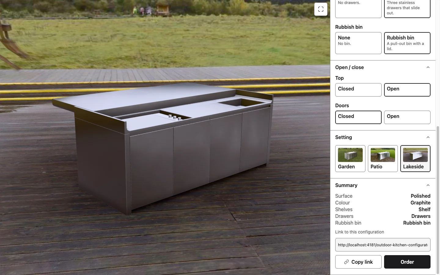 Polished graphite finish on lakeside decking with the top open to show the cooking surface and controls